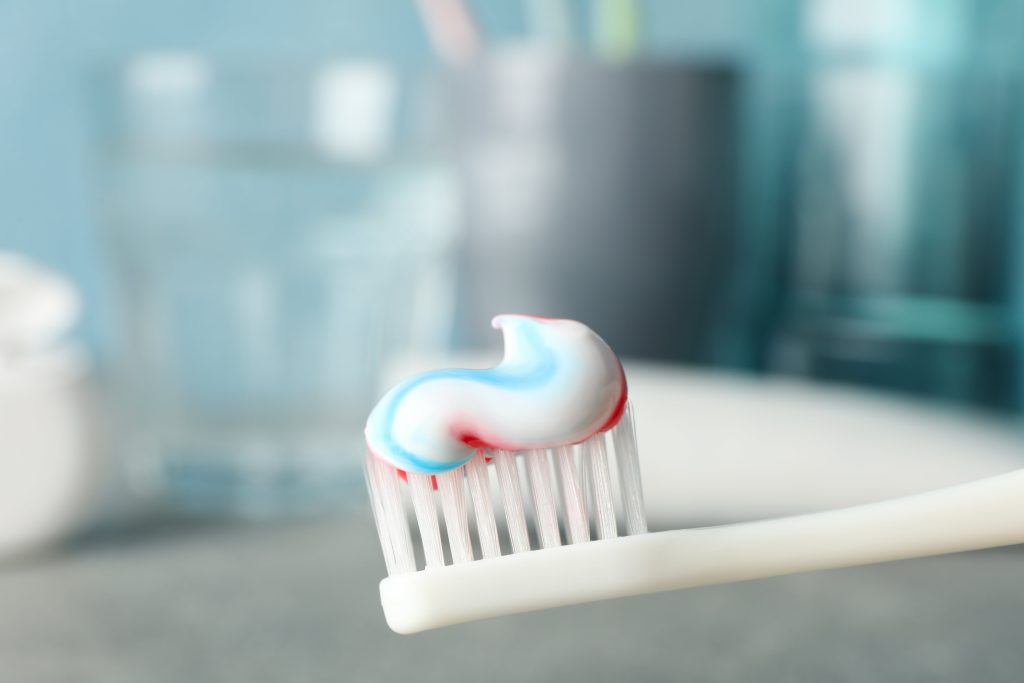 closeup of a toothbrush with a swipe of toothpaste